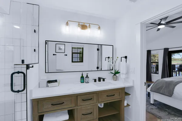 a en suite bathroom with a double vanity sink shower and mirror