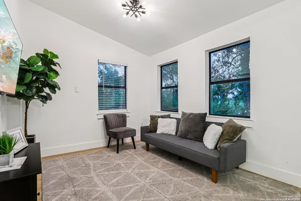 a bedroom with a bed and a potted plant