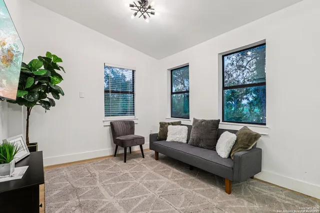 a bedroom with a bed and a potted plant