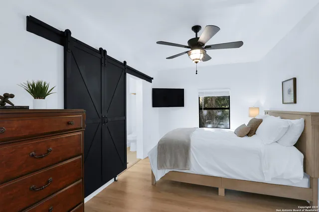 a bathroom with a double vanity sink a toilet a mirror and shower