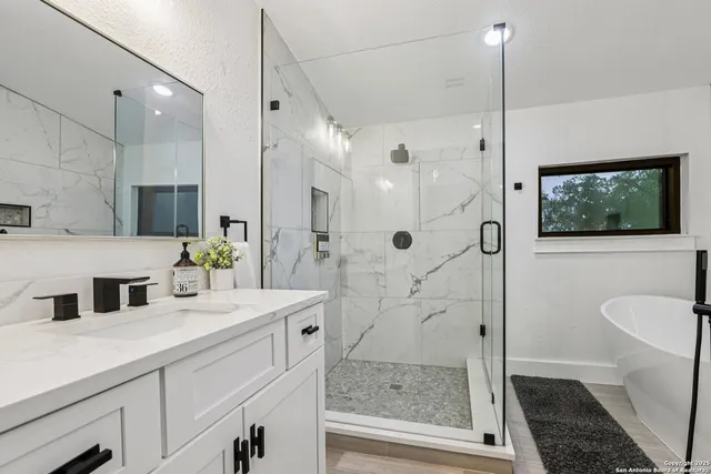 a bedroom with a bed a dresser with wooden floor