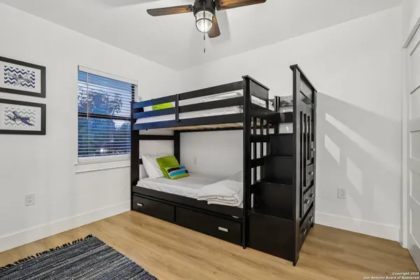 a bathroom with a sink mirror and vanity