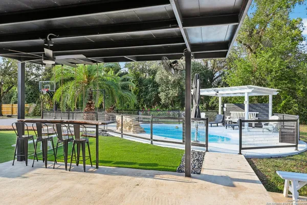 a swimming pool with outdoor seating and yard