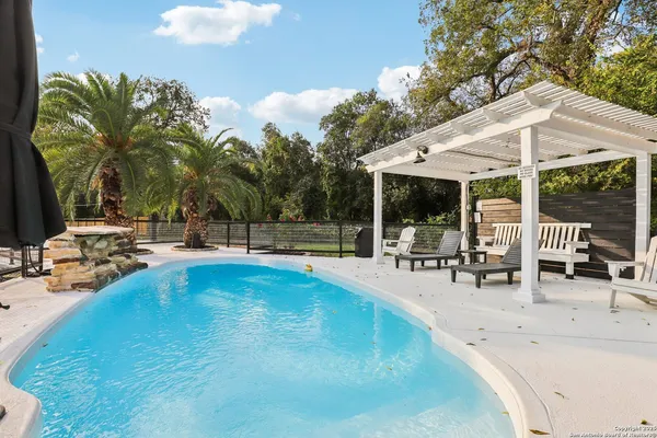 a view of a house with backyard and sitting area