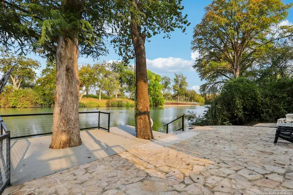 an aerial view of a house with backyard space and patio