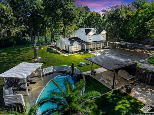 a view of a house with backyard and sitting area