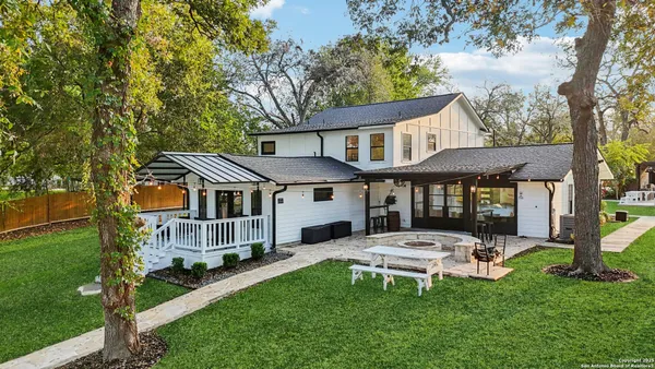 an aerial view of a house with a yard