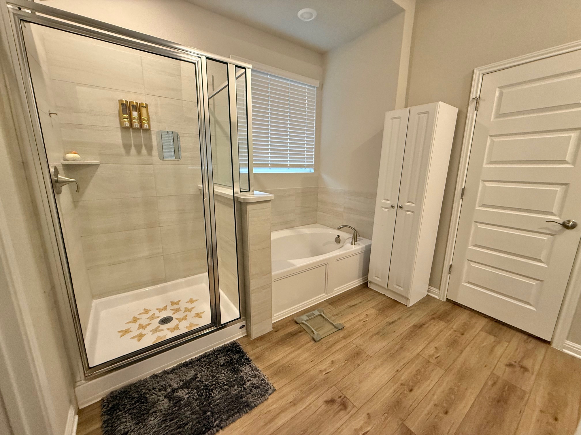 602 Sue Peaks Loop Dripping Springs, TX 78620 - Photo 27 of 39 a bathroom with a bathtub and a glass door shower