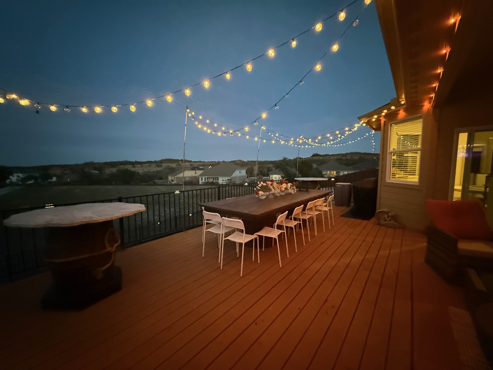 602 Sue Peaks Loop Dripping Springs, TX 78620 - Photo 3 of 39 a view of a patio with table and chairs with wooden floor and fence