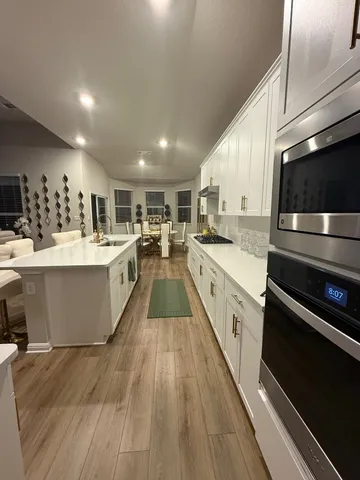 a living room with furniture dining area and a window