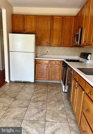 a kitchen with stainless steel appliances granite countertop a refrigerator sink and cabinets