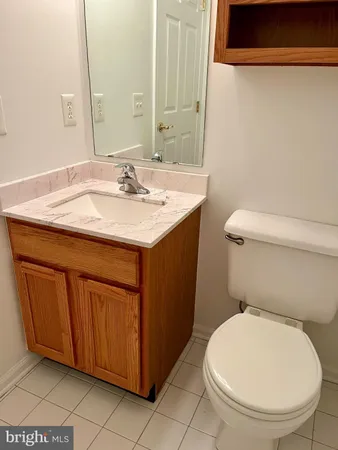 a bathroom with a sink a toilet and mirror