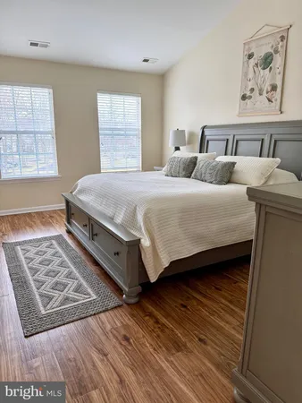a spacious bedroom with two beds and a window
