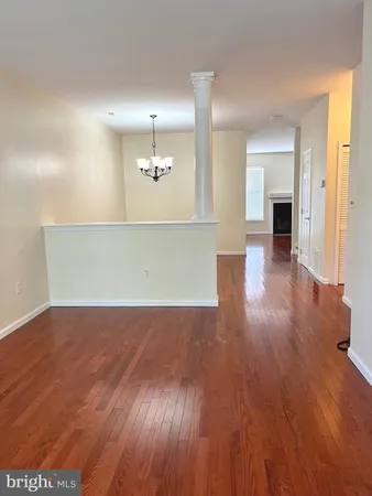 a view of a room with wooden floor and staircase
