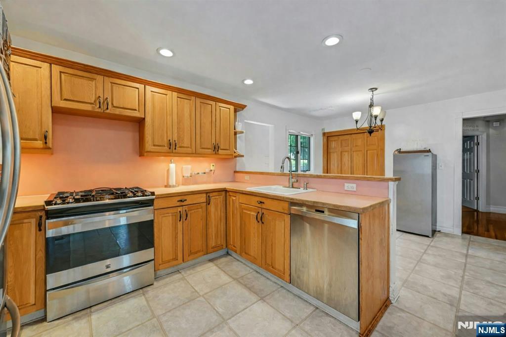 44 West Midland Avenue Paramus, NJ 07652 - Photo 9 of 19 a kitchen with stainless steel appliances granite countertop a stove a sink and a refrigerator