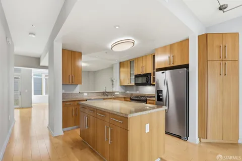 a view of a kitchen with an entryway and a window