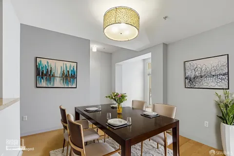 a view of a dining room with furniture and wooden floor