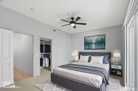 a bedroom with a bed and a painting on the wall