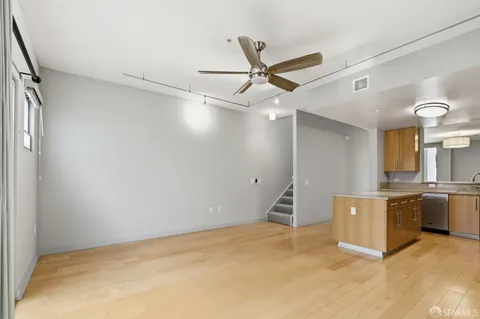 a large kitchen with cabinets and stainless steel appliances