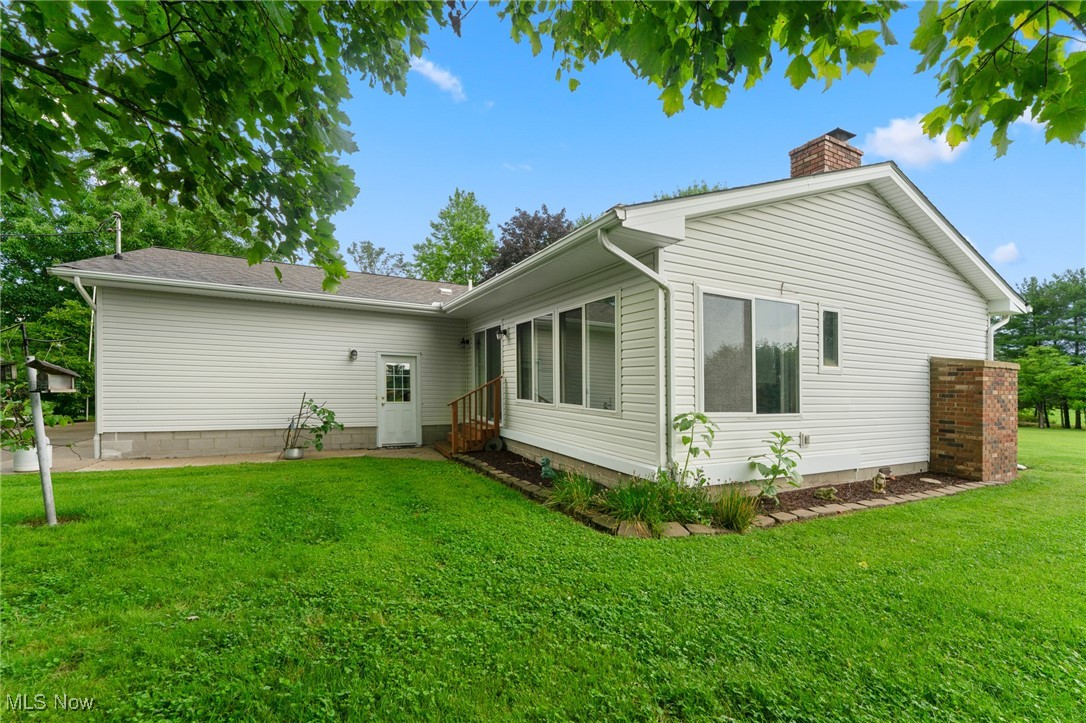 744 Johnson Plank Road Warren, OH 44481 - Photo 27 of 39 Back of property with a chimney and a lawn