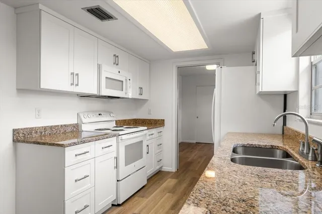 an empty room with a chandelier fan