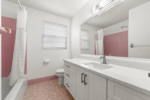 a bathroom with a tub sink and mirror