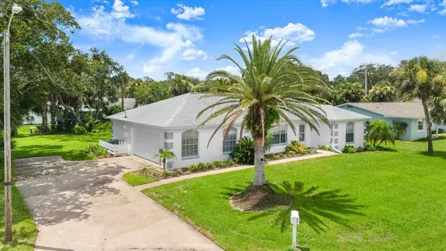 a front view of house with yard and green space