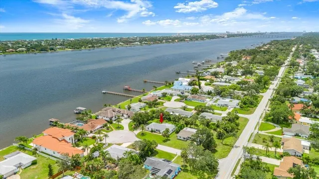 an aerial view of residential houses with outdoor space and trees