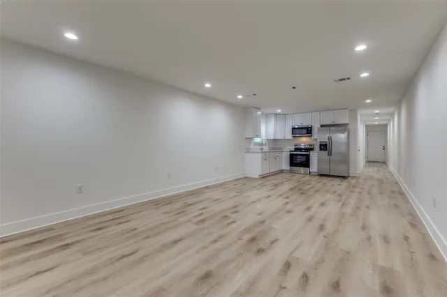 a view of kitchen and refrigerator