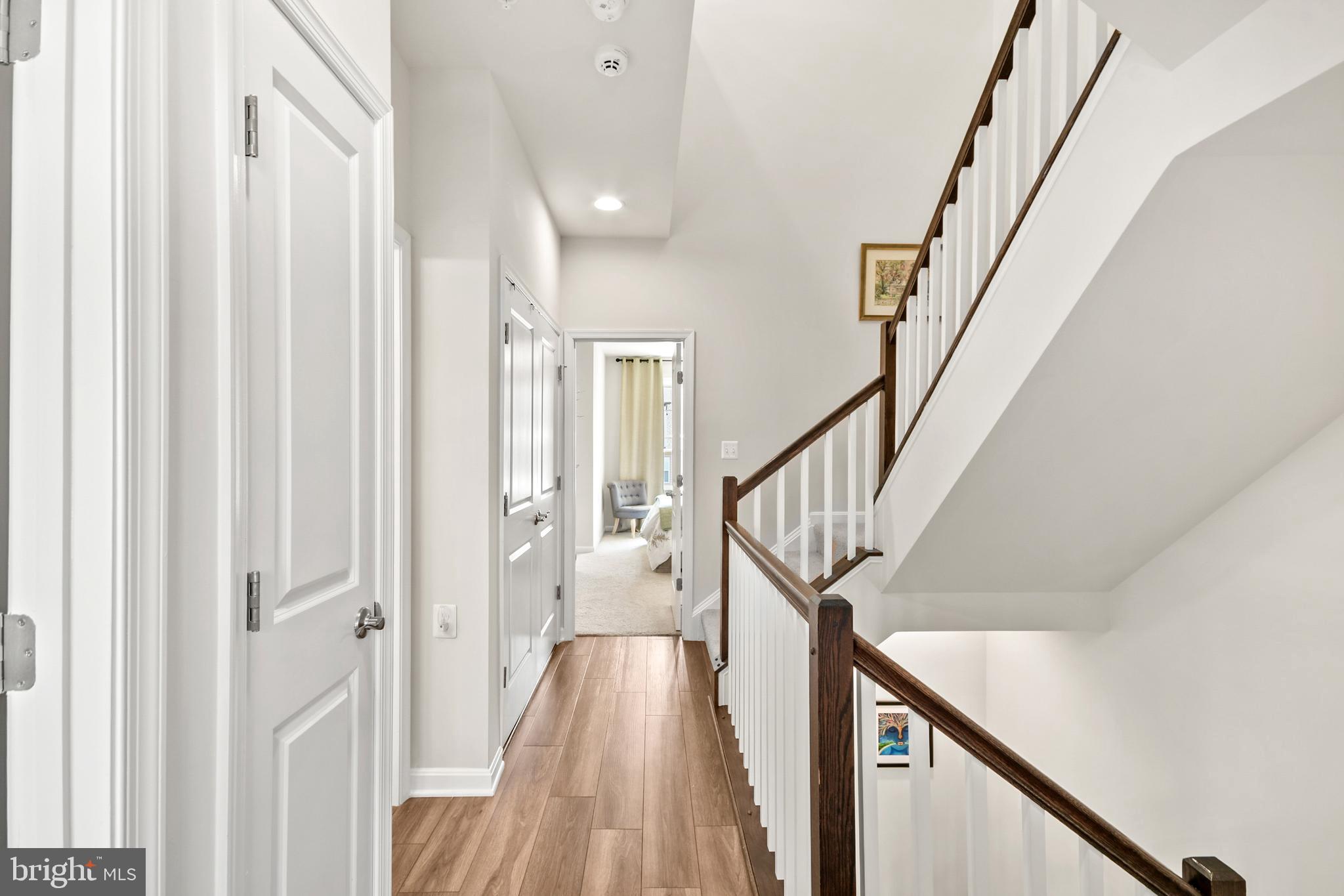 933 Holden Road Frederick, MD 21701 - Photo 42 of 80 a view of a hallway with wooden floor and staircase