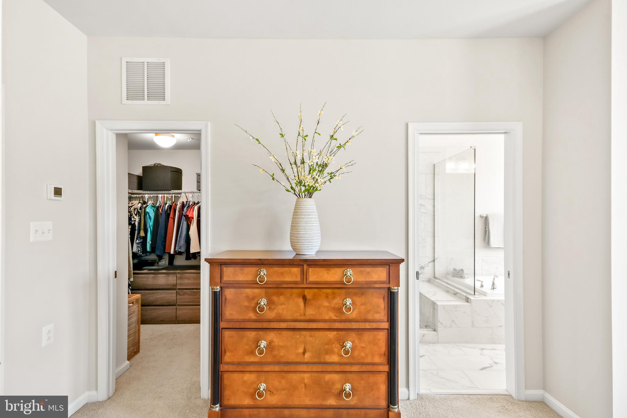 933 Holden Road Frederick, MD 21701 - Photo 43 of 80 a view of a hallway with wooden floor and a large mirror