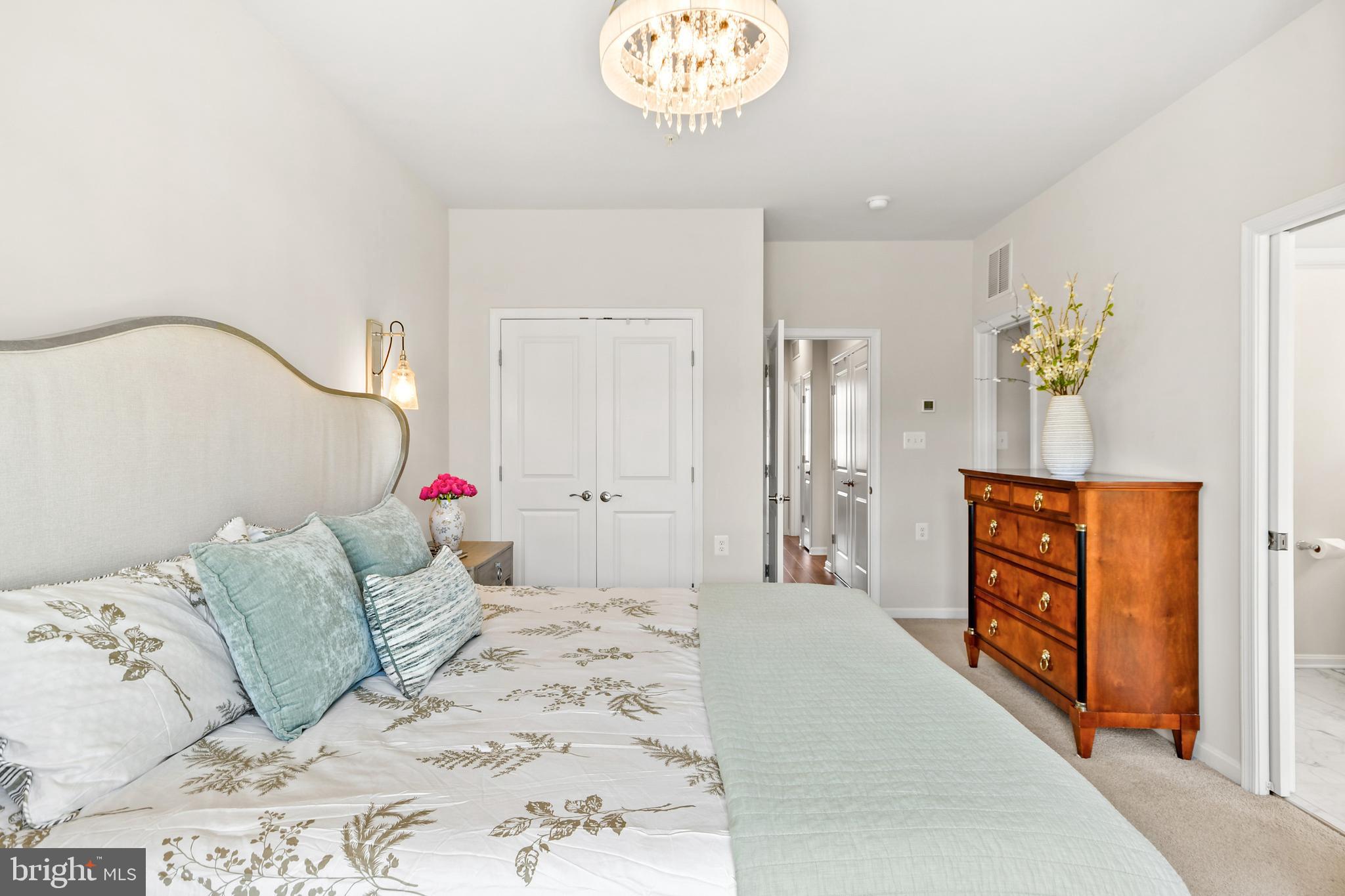 933 Holden Road Frederick, MD 21701 - Photo 44 of 80 a bedroom with a bed and a chandelier