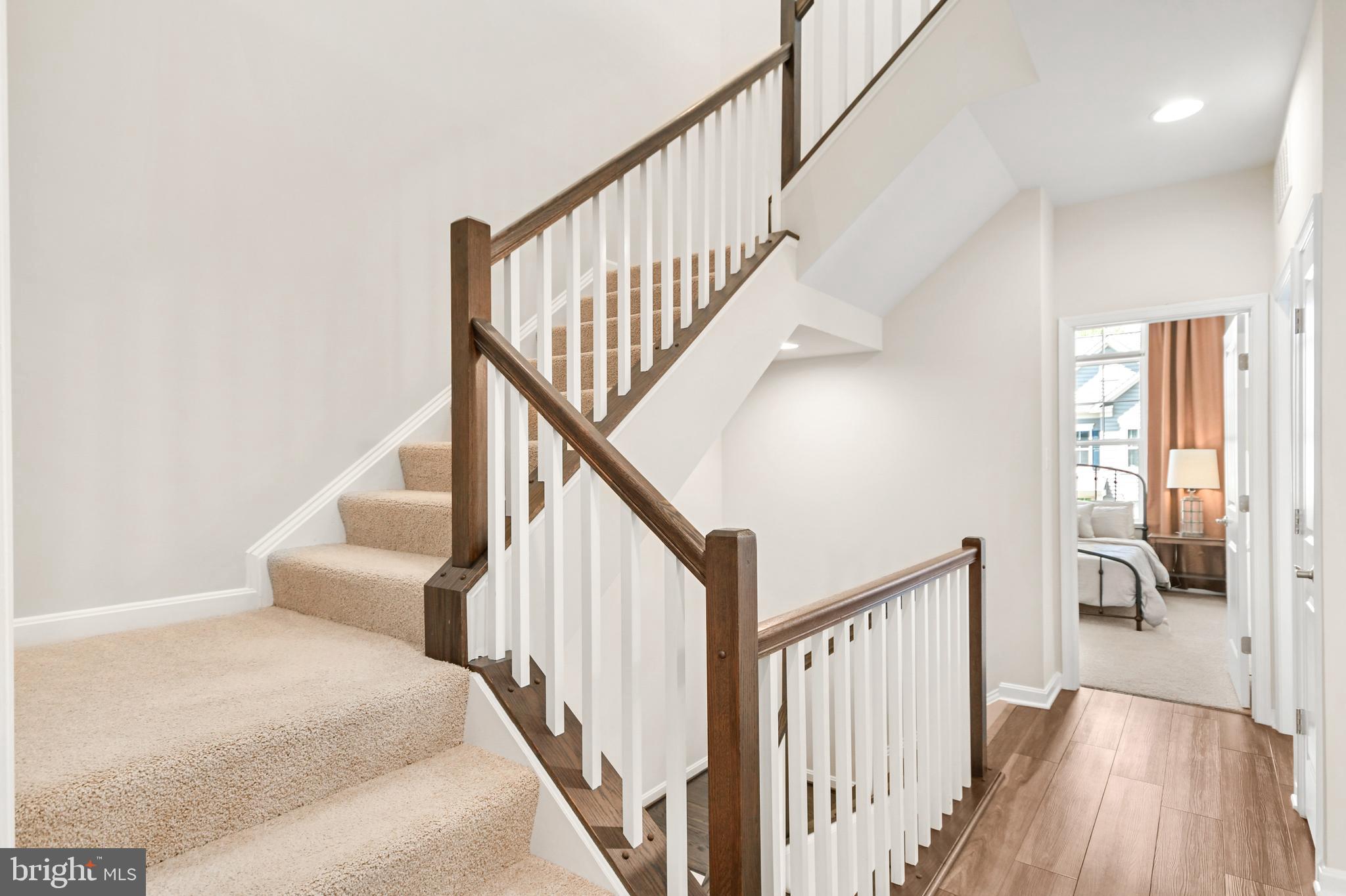 933 Holden Road Frederick, MD 21701 - Photo 49 of 80 a view of staircase with wooden floor and a rug