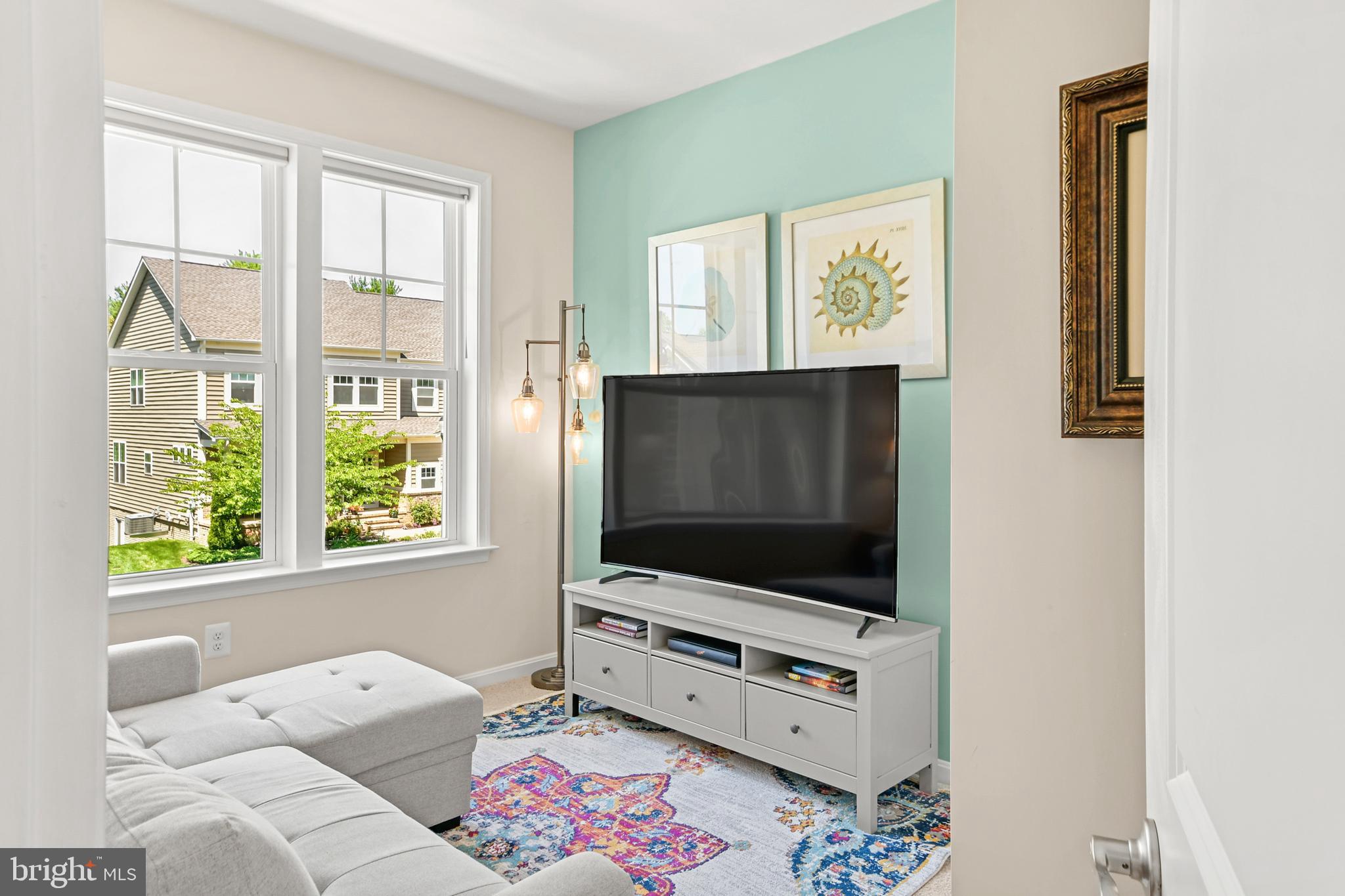 933 Holden Road Frederick, MD 21701 - Photo 52 of 80 a living room with furniture and a flat screen tv