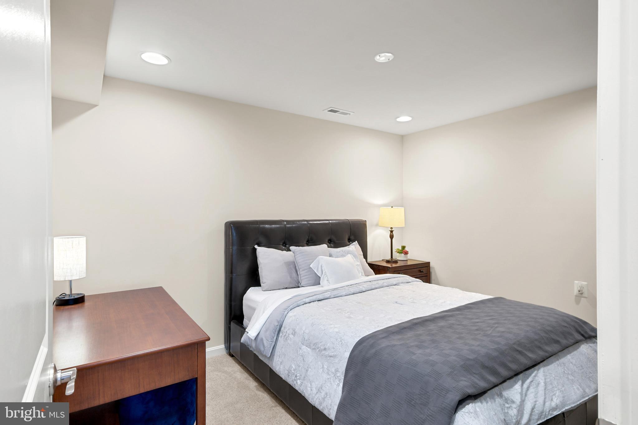 933 Holden Road Frederick, MD 21701 - Photo 60 of 80 a bedroom with a bed and a night stand