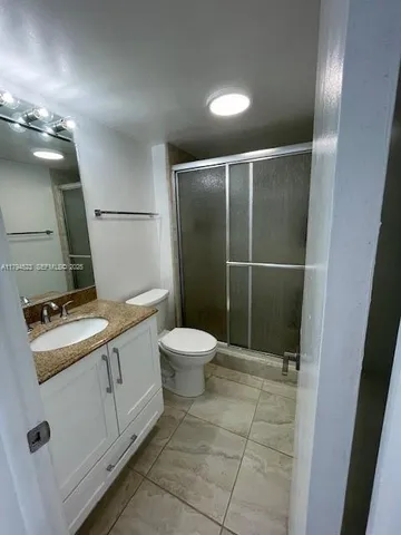 a bathroom with a glass shower door
