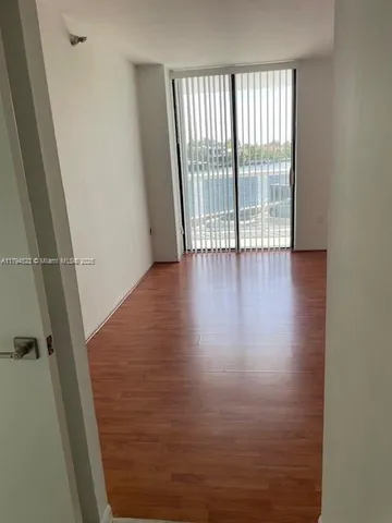 a view of wooden floor and a window