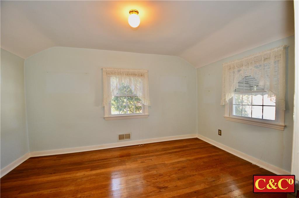 24 Wilbur Road Bergenfield, NJ 07621 - Photo 11 of 27 an empty room with wooden floor and windows