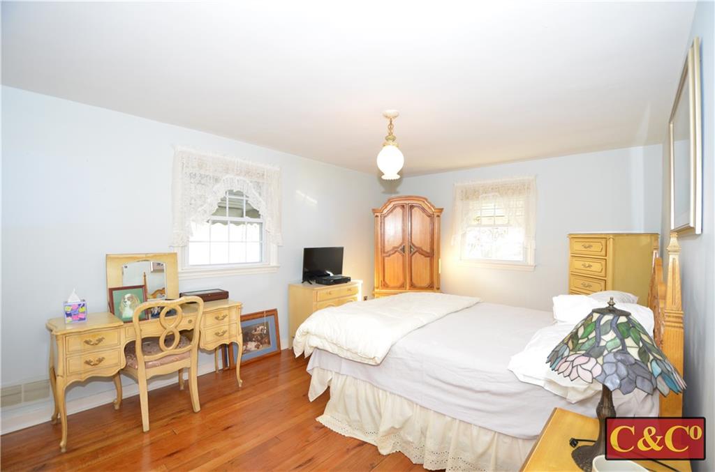 24 Wilbur Road Bergenfield, NJ 07621 - Photo 14 of 27 a bedroom with a bed and wooden floor