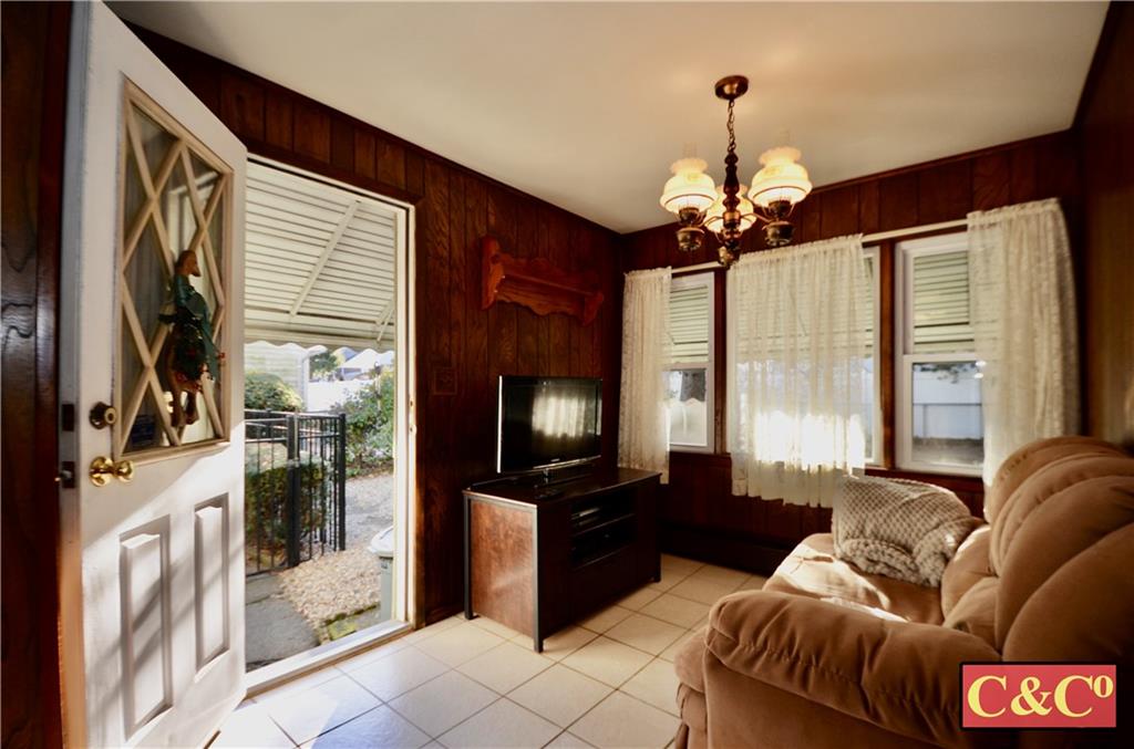 24 Wilbur Road Bergenfield, NJ 07621 - Photo 8 of 27 a living room with furniture and a flat screen tv