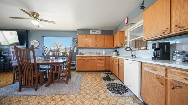 a kitchen with a dining table cabinets and appliances