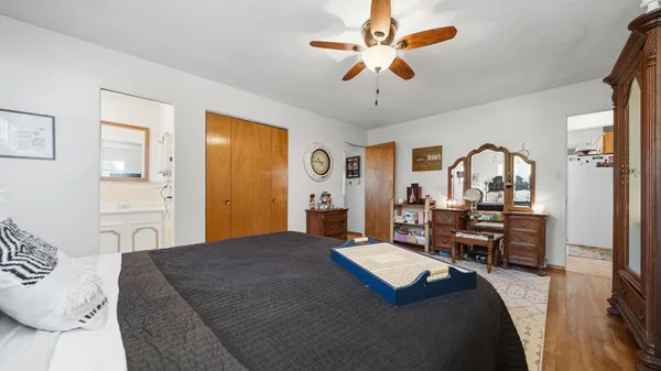 a bed room with a bed mirror and a chandelier