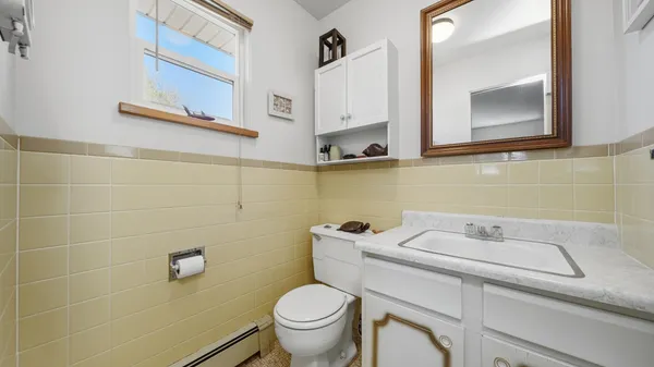 a bathroom with a sink toilet and mirror