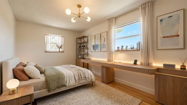 a bedroom with a bed and a chandelier