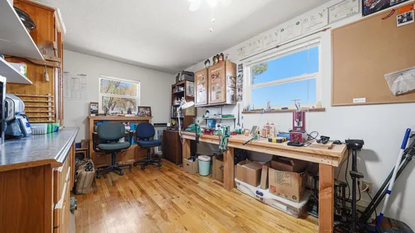 a view of a workspace with furniture and a window