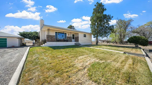 a view of a house with swimming pool and a yard