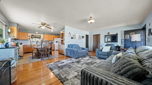 a living room with furniture and a wooden floor