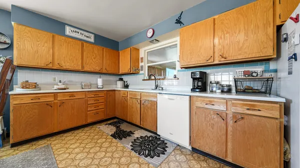 a kitchen with stainless steel appliances granite countertop a sink a stove and cabinets