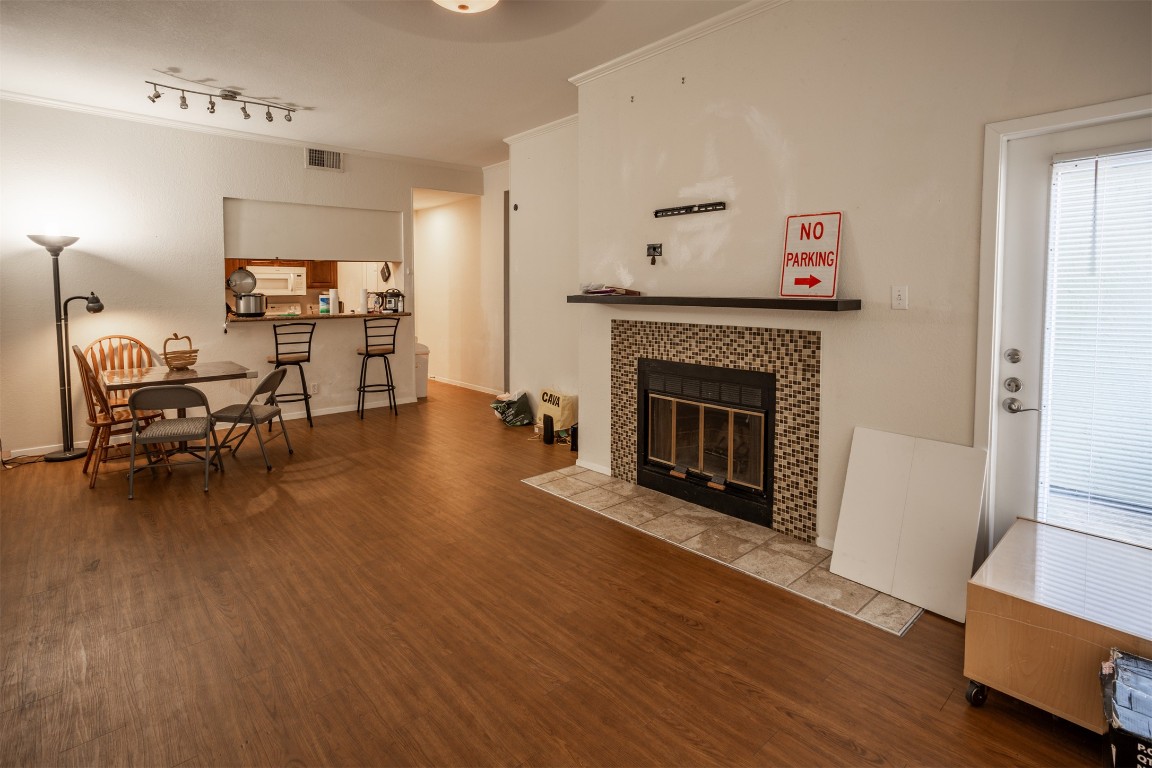 Living room with wood finished floors and a fireplace