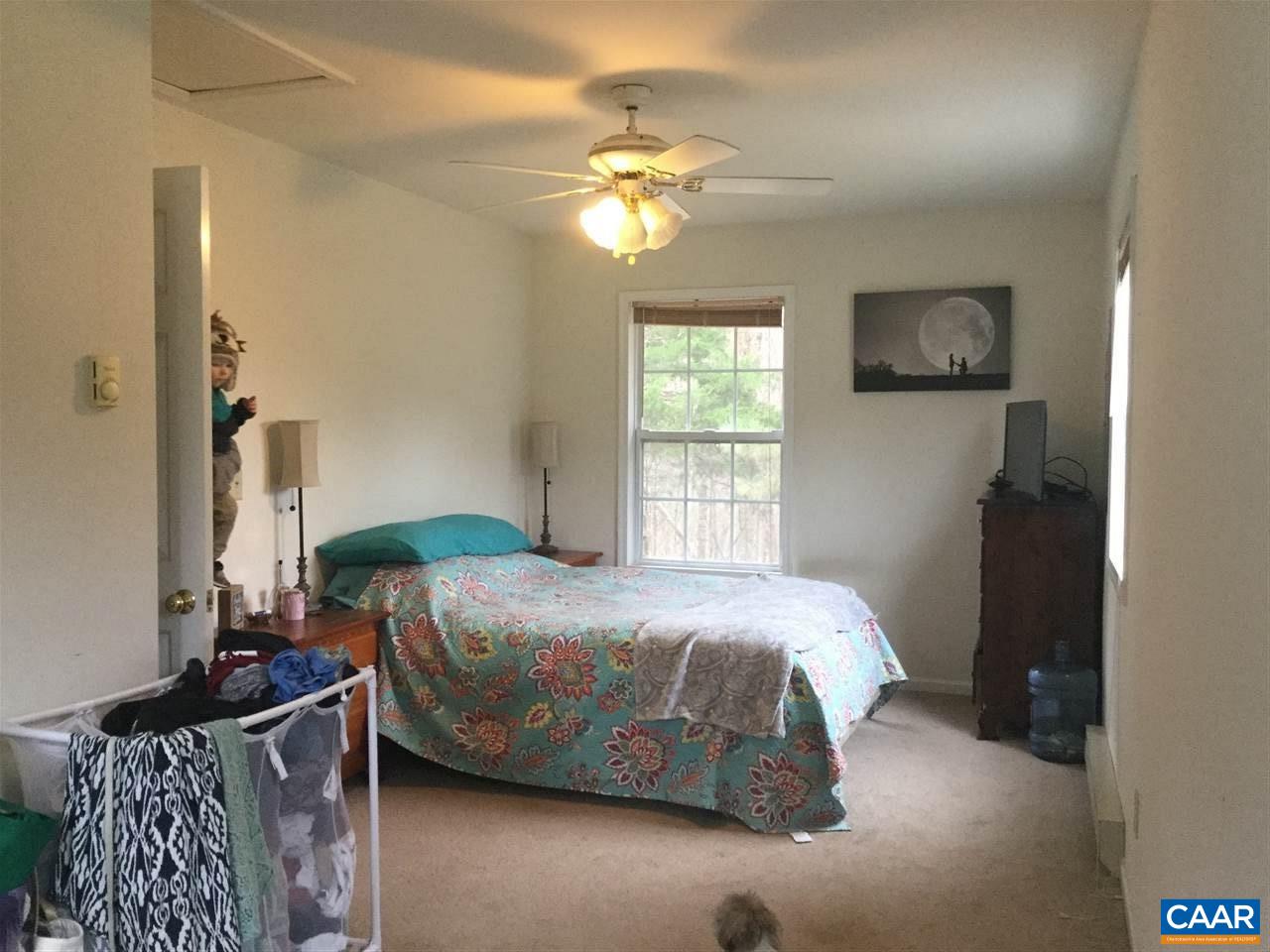 3120 Venable Road Kents Store, VA 23084 - Photo 12 of 15 a bedroom with a bed and a chandelier